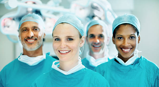 istock Cute female doctor smiling with team 154953426