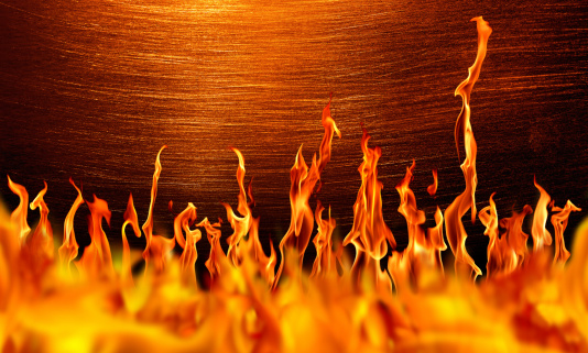 close up shot of actual photograph of fire flames over brushed metal. 