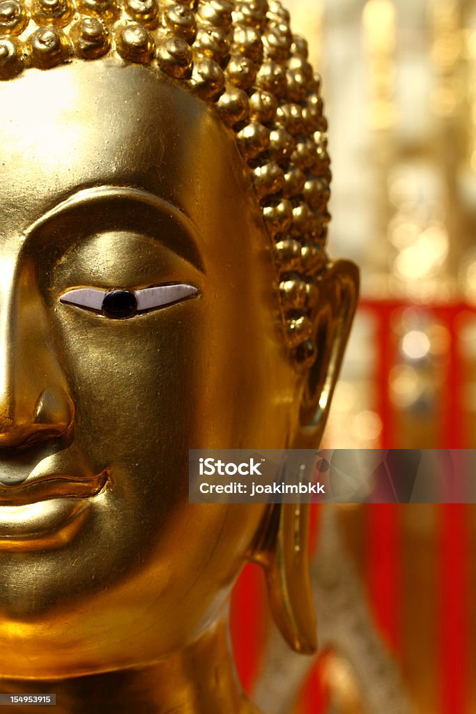 Golden Buddha sculpture in a temple Peaceful Buddha representation in close up with copy space in the blurred area. Further choices of Golden Buddha below: Ancient Stock Photo