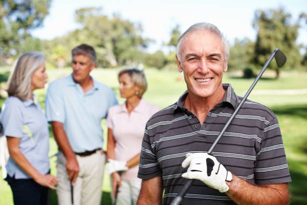 istock Senior golfer with golf club smiling 154953972