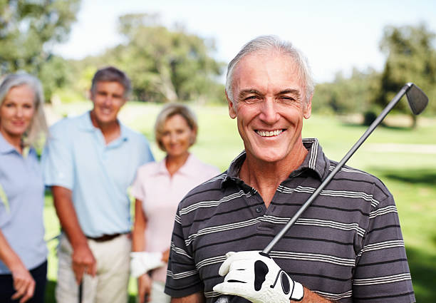 istock Smiling man with a golf club 154953973