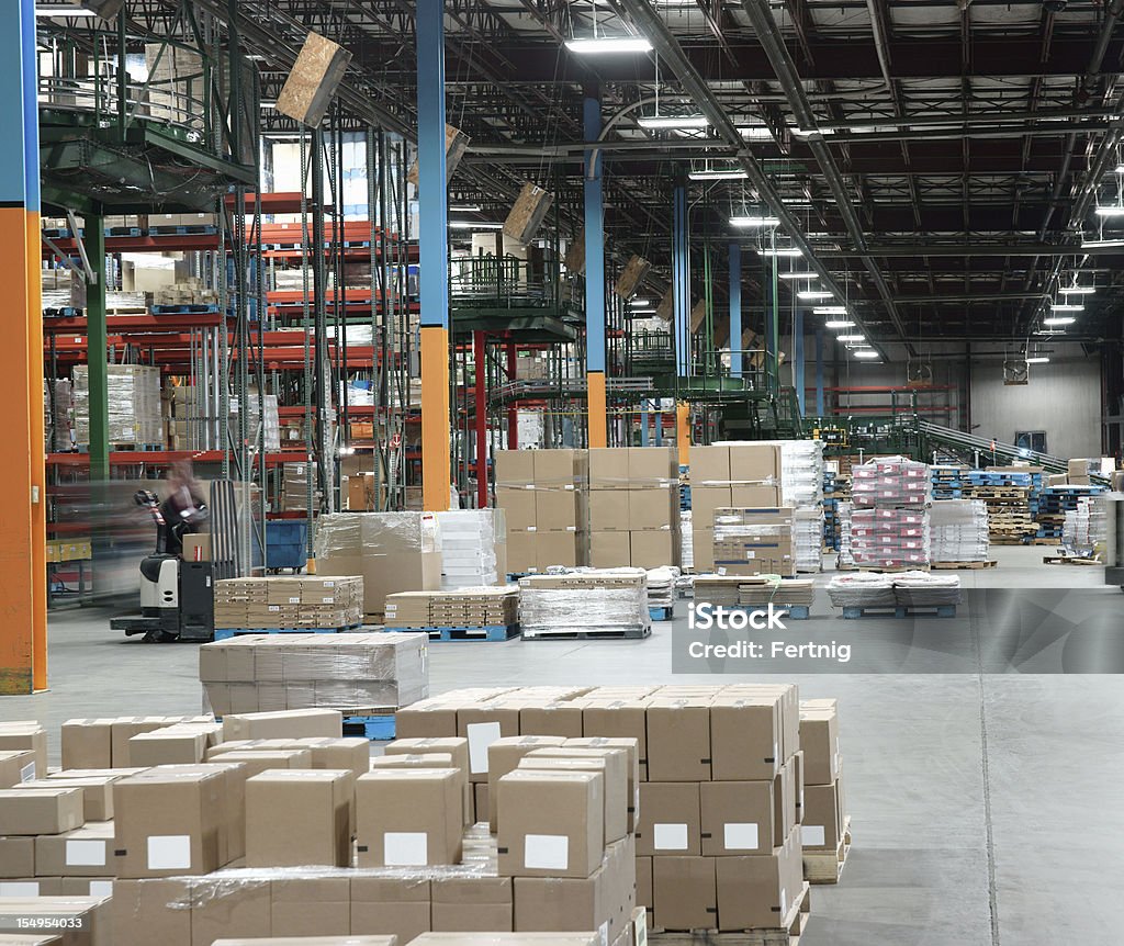 Warehouse distribution center in operation. Warehouse distribution center in operation.  Logistics, warehousing and e-commerce.  Shipping and receiving. Loading Dock Stock Photo
