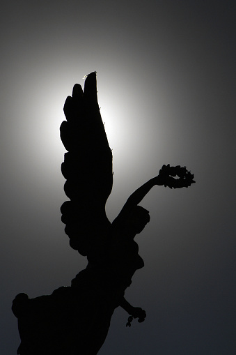 Silhouette of The Angel of Independence (Victory column) over Paseo de la Reforma in downtown Mexico City, Mexico