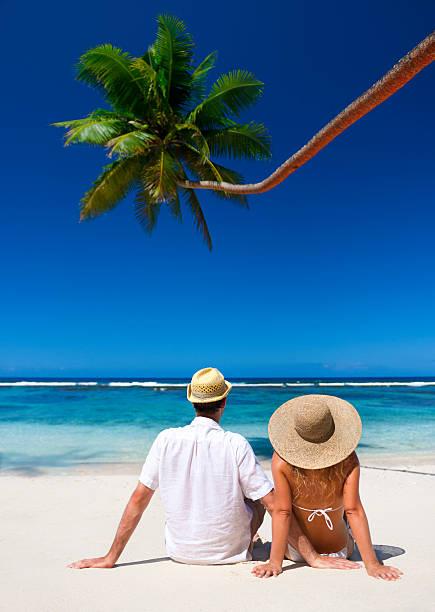 istock Couple relaxing on an idyllic tropical beach 154954446