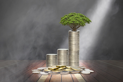 coins stack with lighting and smoke on wooden stage,economic growth concept