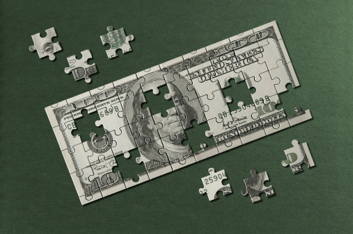 Dollar Bill jigsaw puzzle.Image on green paper textured background.