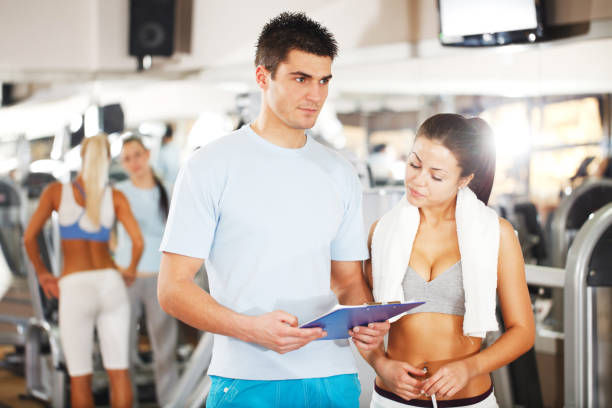 istock Young woman with coach in a gym. 154955541