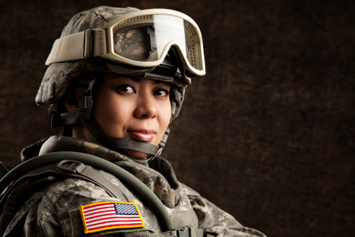 Portrait of a female US military soldier in universal camouflage uniform.