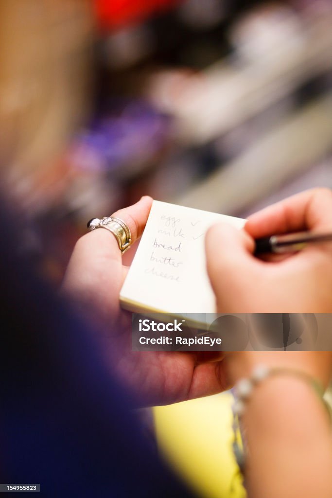 Primo piano di donna le mani come controlli Lista della spesa - Foto stock royalty-free di Adulto