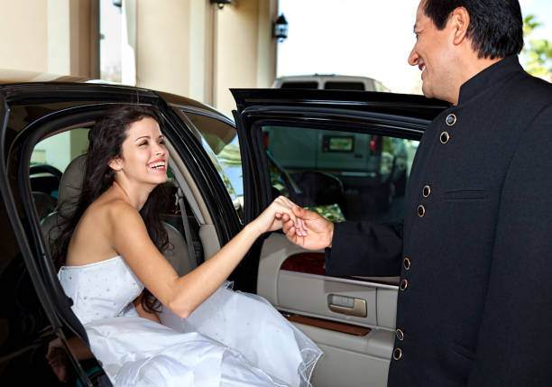 Bride A beautiful bride is helped out of the limousine upon her arrival by her brother. sequence dress stock pictures, royalty-free photos & images