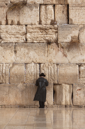 Orthodox Jewish man praying alone at the Wailing Wall in Jerusalem, Israel.
