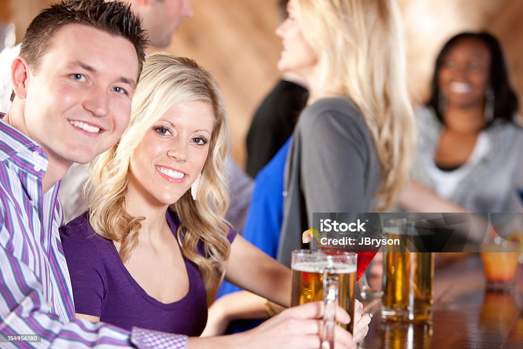 Real People: Young Adult Couples in Bar Caucasian African American  20-29 Years Stock Photo