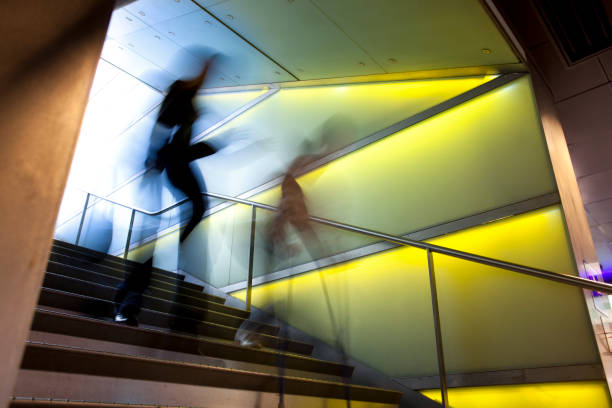 istock Time-lapse of two blurry people walking down stairs 154956221