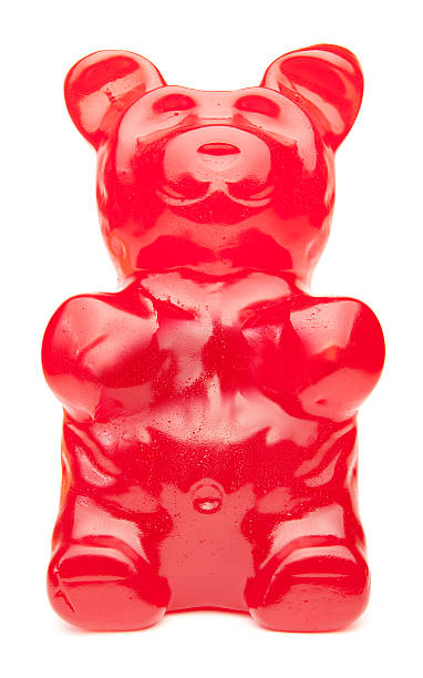 большой красный gummy bear - isolated on red стоковые фото и изображения