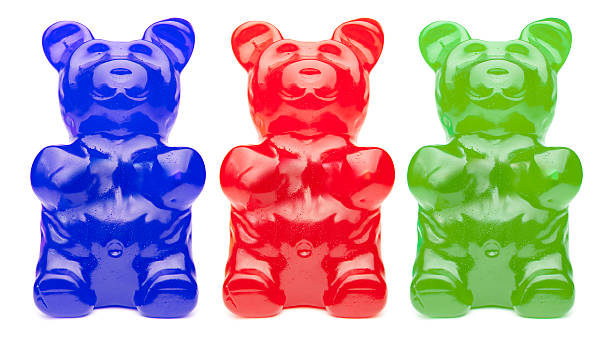 drei bunte gummy bears - gummibärchen stock-fotos und bilder