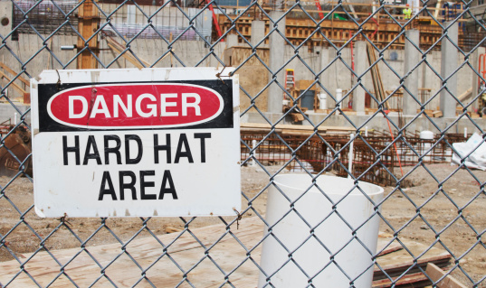 a danger hard hat area sign located at a construction site.