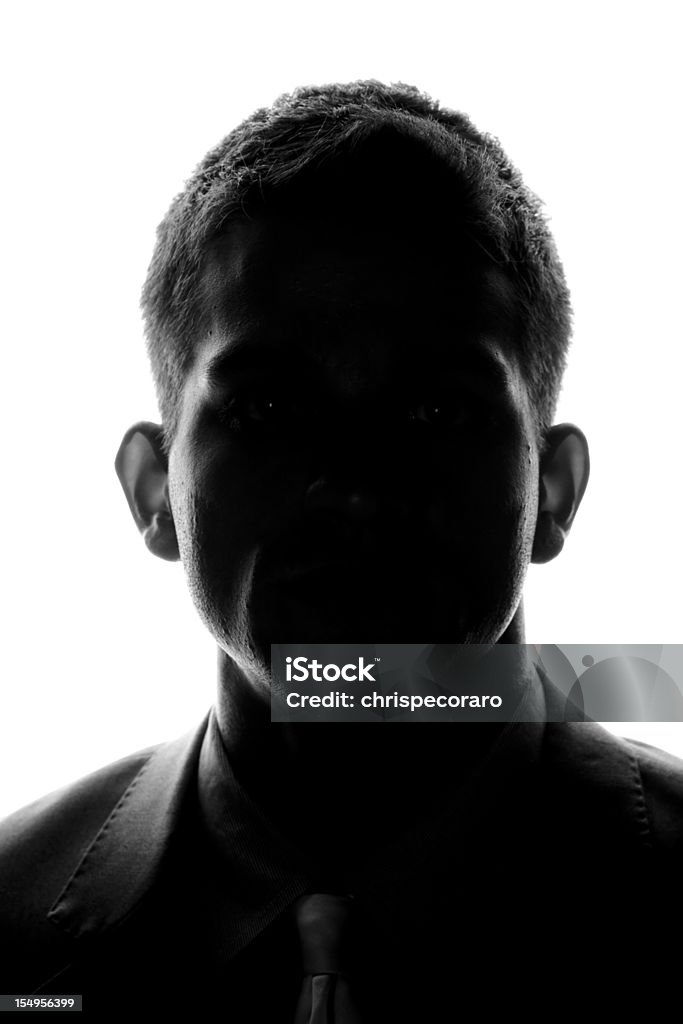 Anonymous - Front Silhouette Silhouette of a young man looking looking at the camera. Men Stock Photo