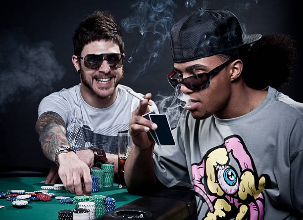 Two friends playing poker. Two friends playing poker. Shot in study with black background. child gambling chip gambling poker stock pictures, royalty-free photos & images