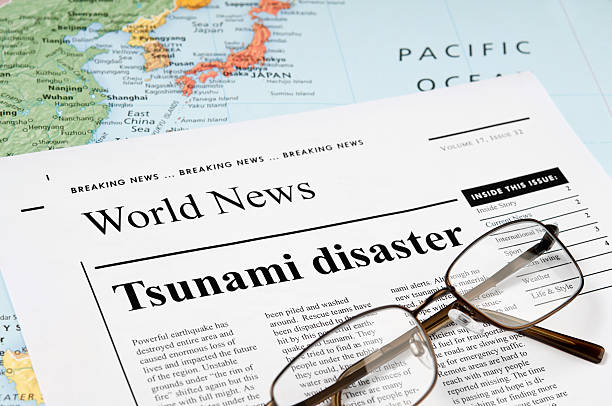 Tsunami Disaster news - III News concept related to tsunami and earthquake news. Map and the reading glasses on the newspaper. 2004 indian ocean earthquake and tsunami stock pictures, royalty-free photos & images
