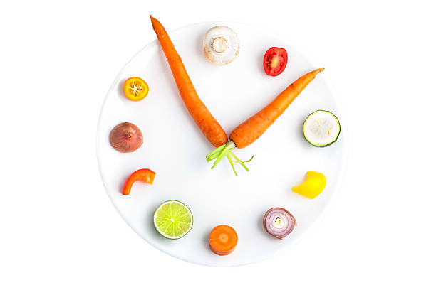 Time for food - clock made from assorted fruit & vegetables Clock with fruits and vegetables as numbers. Isolated on white. carrot isolated vegetable nobody stock pictures, royalty-free photos & images