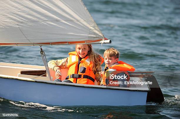 Two Kids Sailing In Small Vessel Stock Photo - Download Image Now - Child, Sailing, Nautical Vessel