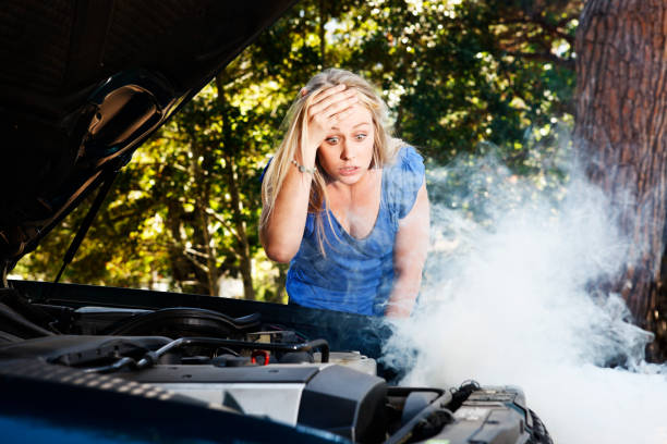 istock Baffled blonde is frustrated by her car's smoking engine 154959166
