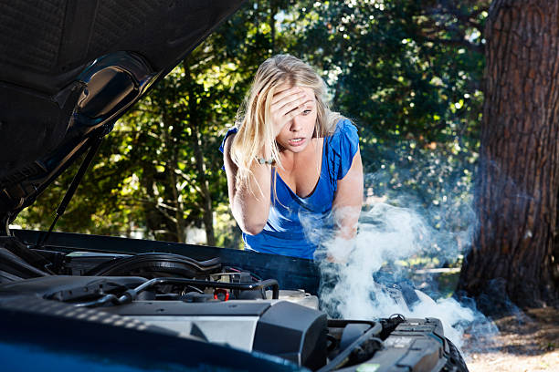 istock Beautiful blonde stranded by broken down car is helpless 154959200