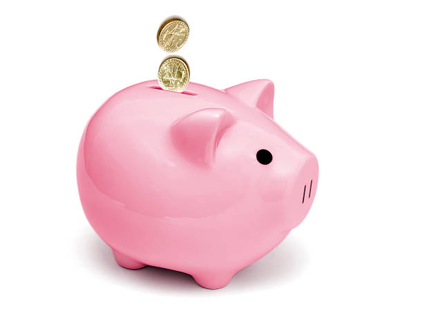 Isolated pink piggy bank with coins  piggy bank gold british currency pound symbol stock pictures, royalty-free photos & images