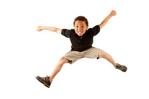 Excited 8year Old Mixed Race Boy Jumping On White Stock Photo