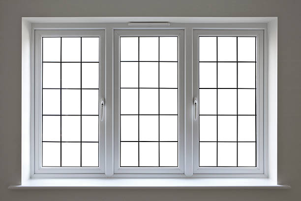 white leaded glass window a modern UPVC double glazed window unit set into a recess with a window sill. This is an expensive window unit and finely made. All of the individual panes have been blanked out with a clipping path to enable the user to place a background of choice.  For best results: Make a selection, expand 1 pixel, feather 0.6 pixels... pvc stock pictures, royalty-free photos & images