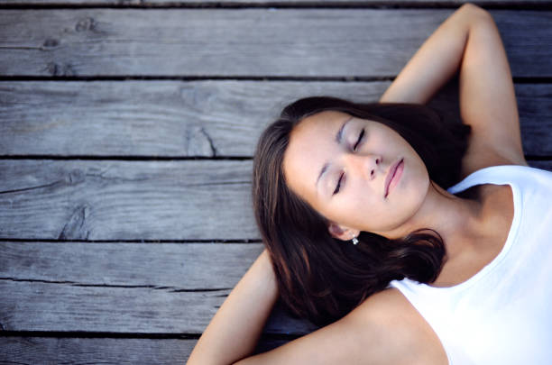 Beautiful girl resting on a wooden pier