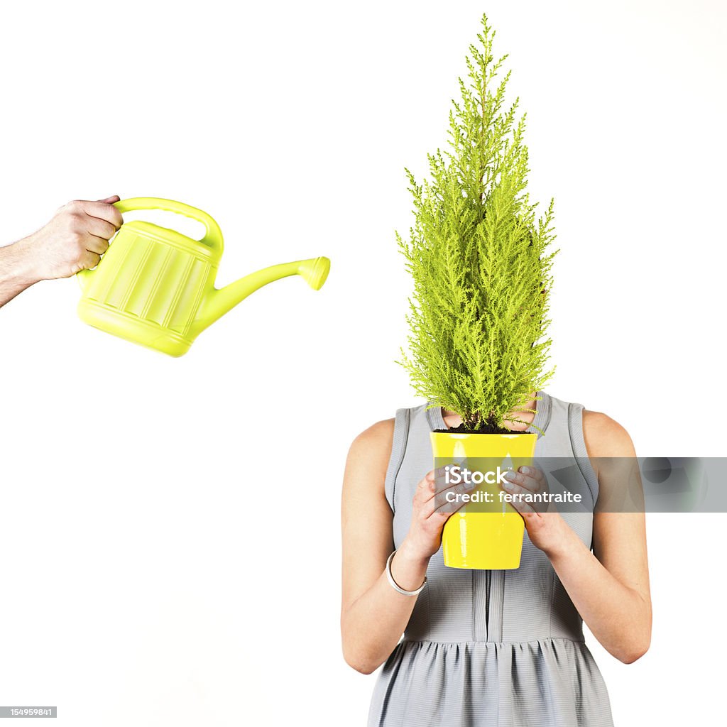 Woman holding flowerpot Woman holding flowerpot while man waters it White Background Stock Photo