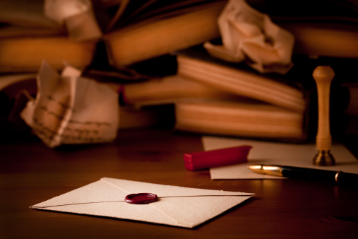 Wax sealed envelope with books and drafts in background. Canon 1ds Mark III