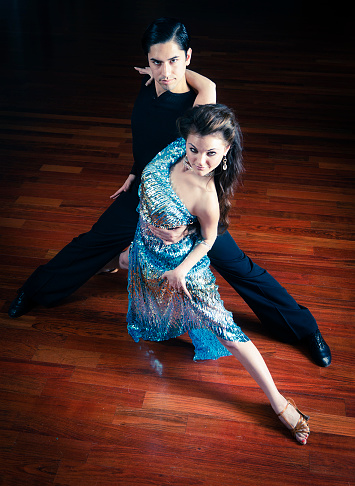 A young couple in a ballroom dancing pose.