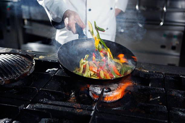 Chef cooking vegetables chef tossing vegetables. skillet stock pictures, royalty-free photos & images