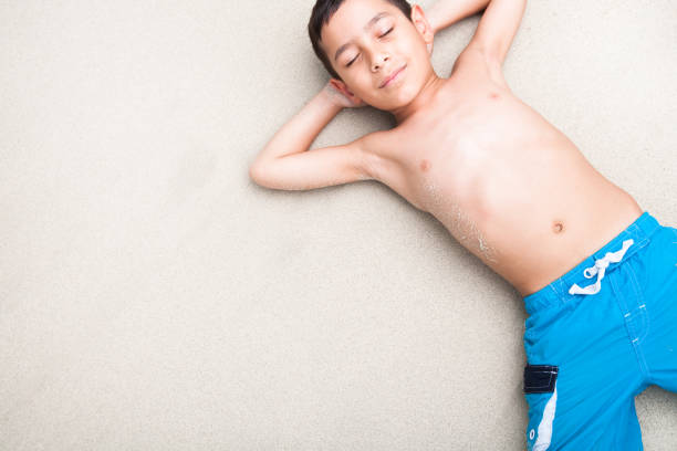 istock Young boy relaxing on the beach 154960653