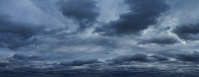 Rain over dramatic sky. Panoramic shot.