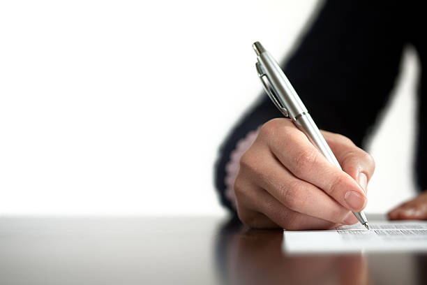 istock Closeup of  hand writing with a silver pen 154960934