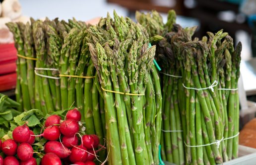 Detail of a bunch of red radish and asparagus.
