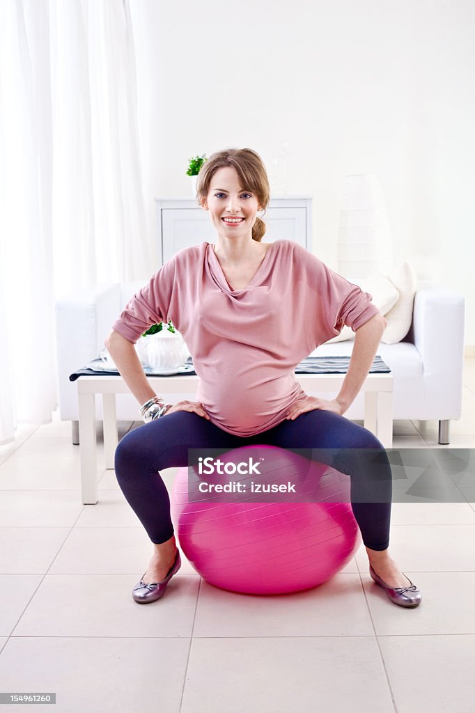 Pregnant woman doing exercises  20-24 Years Stock Photo