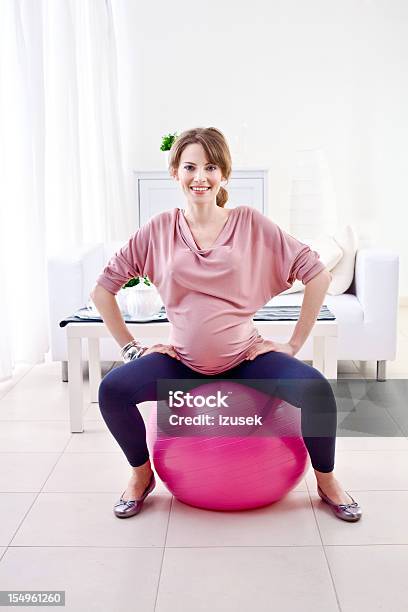 Pregnant Woman Doing Exercises Stock Photo - Download Image Now - 20-24 Years, Abdomen, Adult