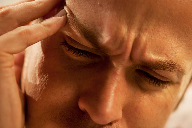 istock man rubbing head in pain 154961279