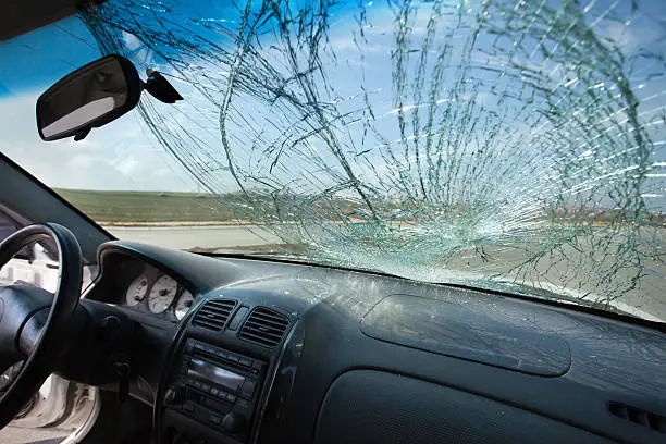 Photo of Inside of car with the broken windshield. Road accident