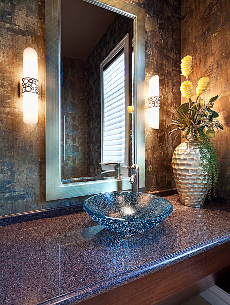 Designer Powder Room A beautiful glass vessel sink in an elegant powder room. powder room stock pictures, royalty-free photos & images