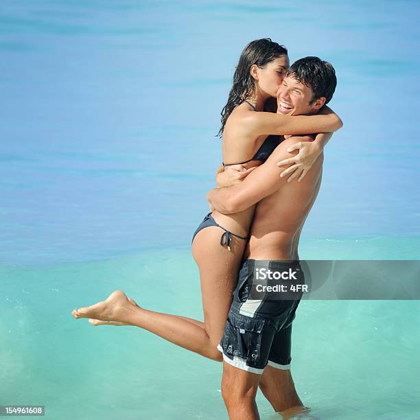 Vacation Love Couple Kissing In The Shore Break Stock Photo - Download Image Now