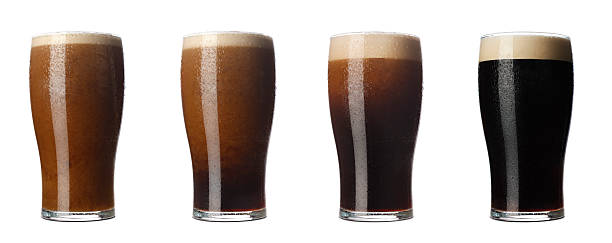 Four stages of Stout Four stages of a pint of stout from the moment it is poured till it is ready to drink. amber black photography stock pictures, royalty-free photos & images