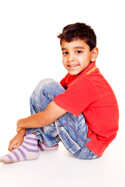 istock One Casual Little Indian Boy Sitting Isolated on White 154961716
