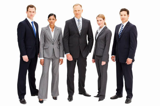 A group of businesspeople with serious expressions is standing in a line looking at the camera. Horizontal shot. Isolated on white.