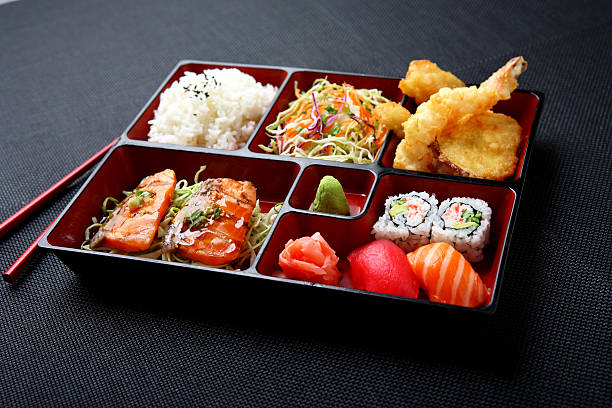 Bento - Salmon & Sushi Japanese Combination Bento with Salmon Teriyaki, Tempura, California Rolls & Sushi empty bento box stock pictures, royalty-free photos & images