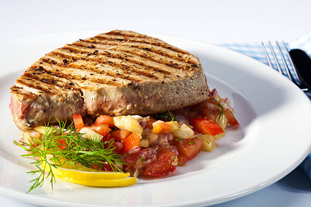 Tuna steaks with grill marks on a pan